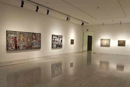 Interior view of the Picasso Museum showing paintings on the white walls