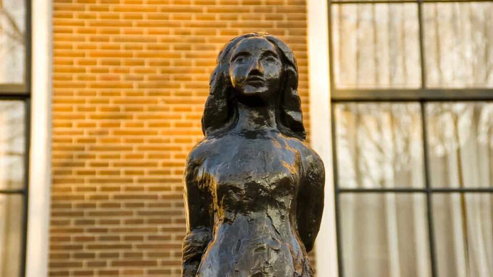 Black statue of Anne Frank outside of the museum