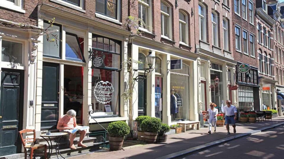 view of the pretty facades of several shops on a street