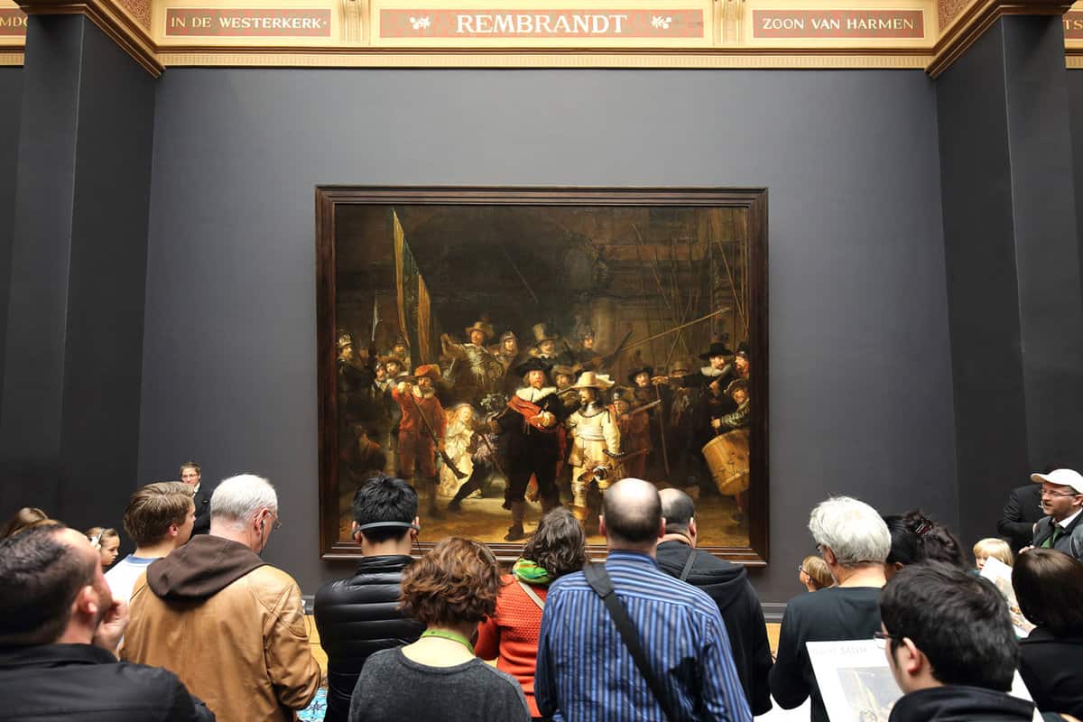 Group of people viewing a historical painting
