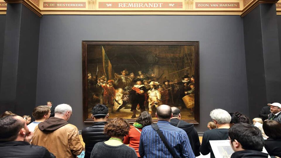 Group of people viewing a historical painting