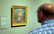 close up of visitor viewing a painting of van gogh