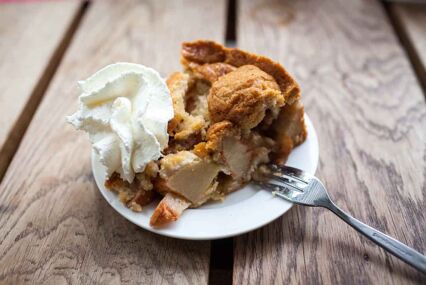 Close up of Dutch apple pie with whipped cream