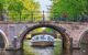 Boat under a bridge at daytime