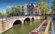 Long tourist boat passing a bridge