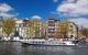 Amsterdam city with boats on canal in city