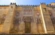 Exterior facade of the Mezquita with intricate moorish design and golden stonework