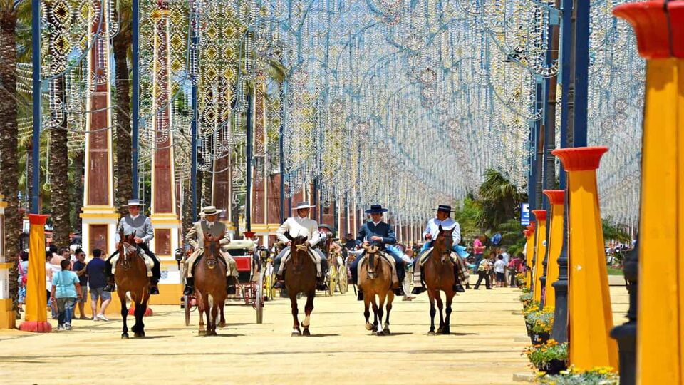 A line of riders on horseback ride through the fair