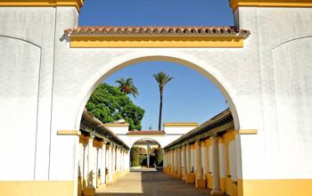 Looking through an arch down a row of columns