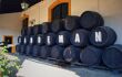 Barrels stacked, some with letters that spell out Sandeman