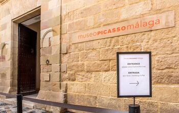 Close up of the museum exterior and entrance, in golden stone, located in an old classic palace in the city