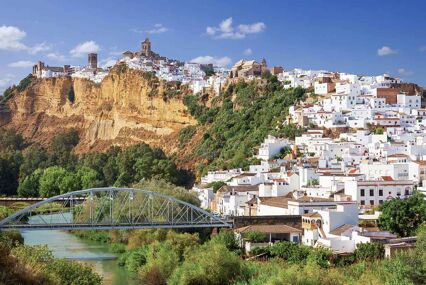 The white village cascades down the side of the hill