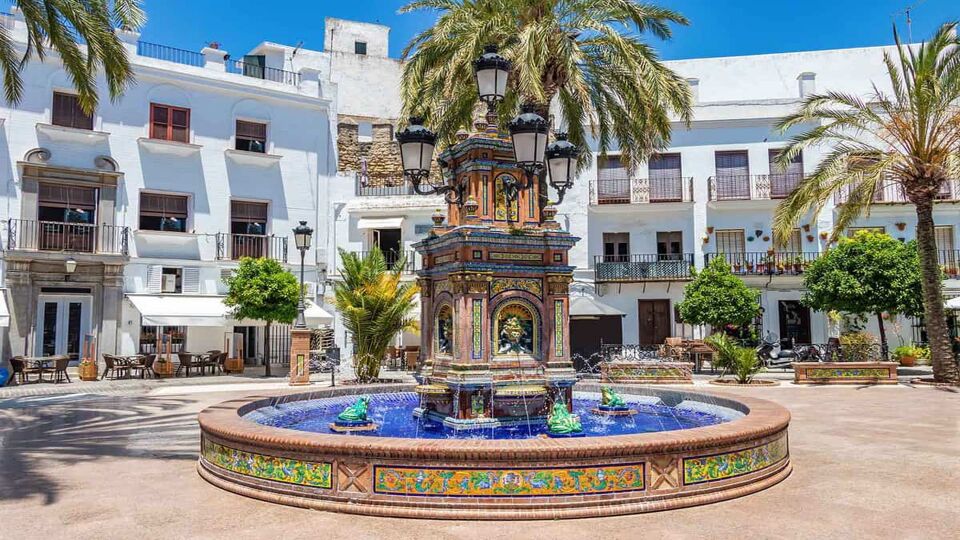 A pretty central square in the white village of Vejer de la Frontera, with intricate and colourful central fountain