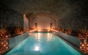 Soothingly low-lit large pool inside the Hammam