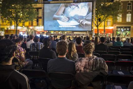 People watching a film on an outdoor screen