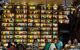 Patrons of Brettos bar smile at the camera. The bar behind them is lined with rows of multicoloured bottles up to the ceiling