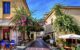 Buildings in Plaka with plants growing up them, and outdoor seating