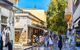 Tourists pass gift and souvenir shops in Plaka