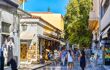 Tourists pass gift and souvenir shops in Plaka