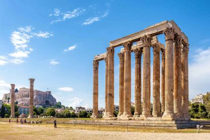 Tourists look small in comparison to the large ruins of the Temple of Zeus