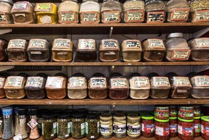 Food shelf with mediterranean herbs and jam in the local market