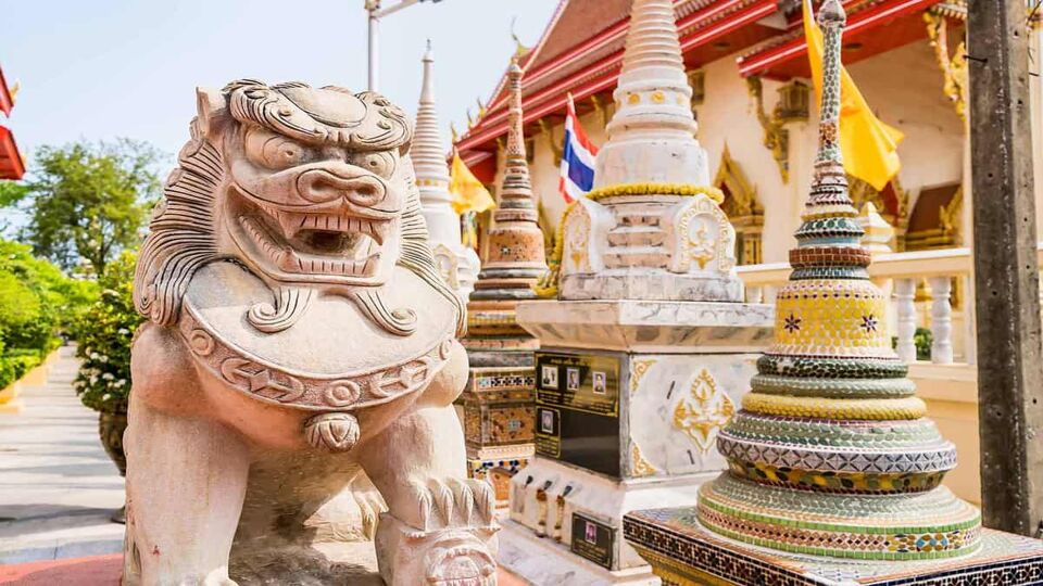 Stone lion statue beside temple