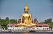 A giant golden Buddha in a relaxed position