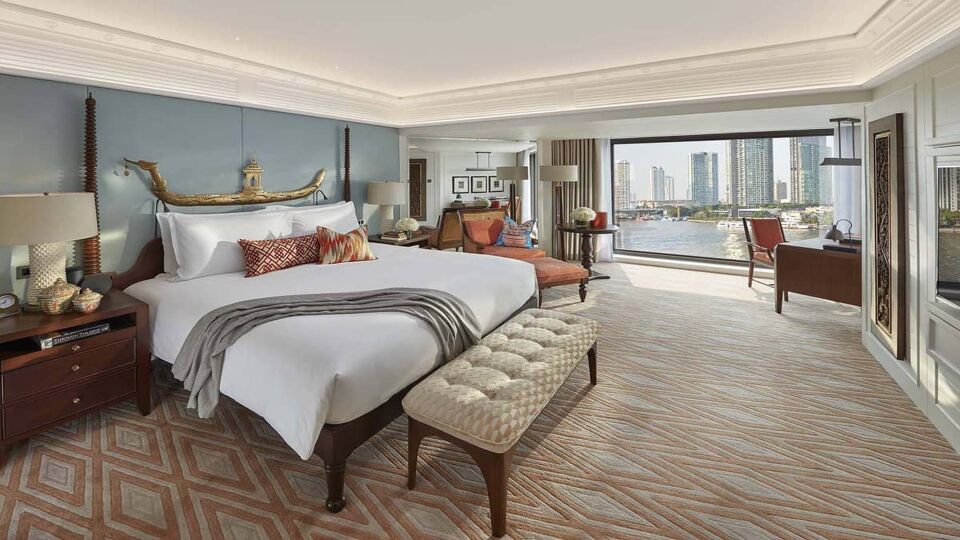 Large carpeted bedroom with river view