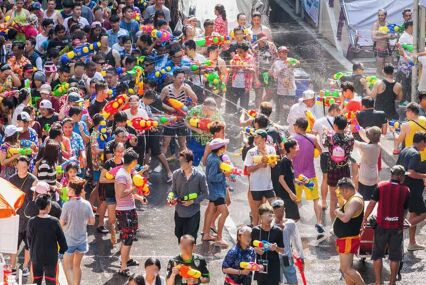 A parade of people having a water fight