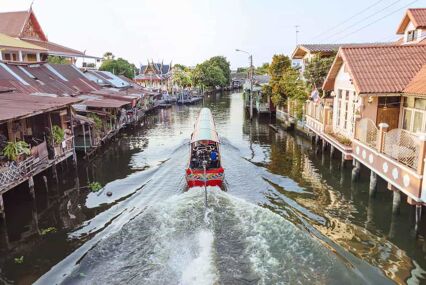 Long tail boat cruising through temples