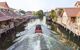 Long tail boat cruising through temples