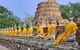 Row of Buddhas in saffron robes