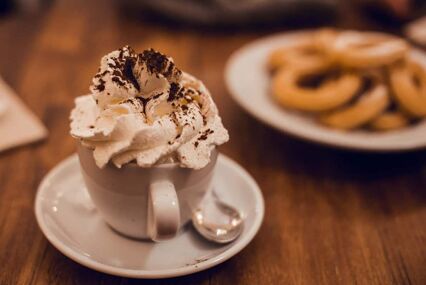 hot chocolate with churros in background