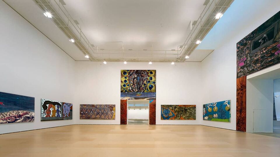 Exhibition room showing a selection of contemporary artworks on white walls