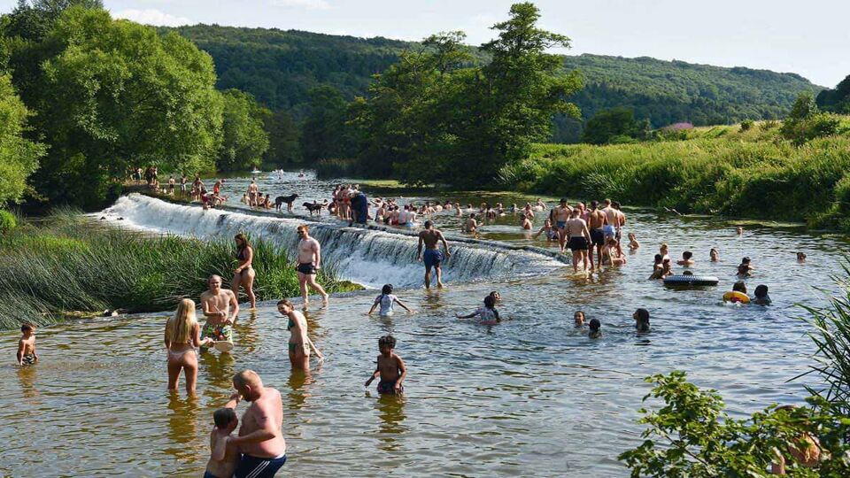 Lots of people swimming in the river's weir
