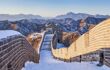 Great Wall view in winter with snow layer over wall and hills behind