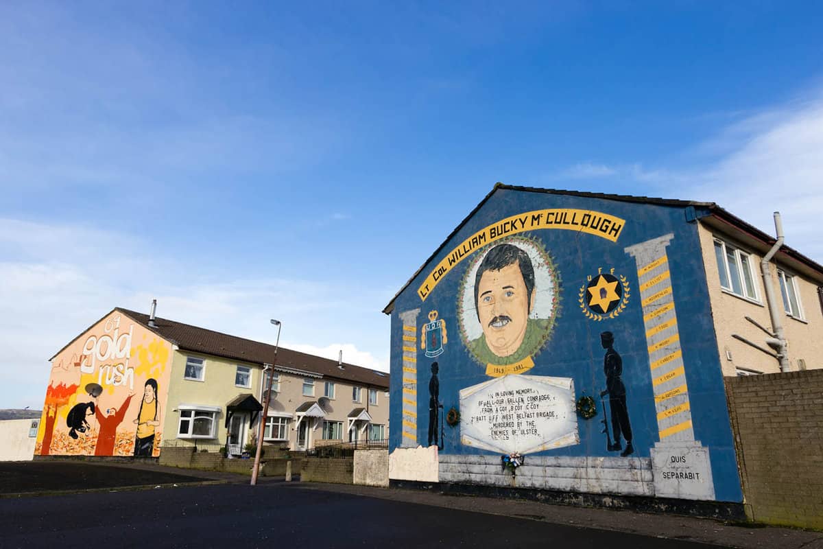 Large graffiti mural on side of a row of terrace houses