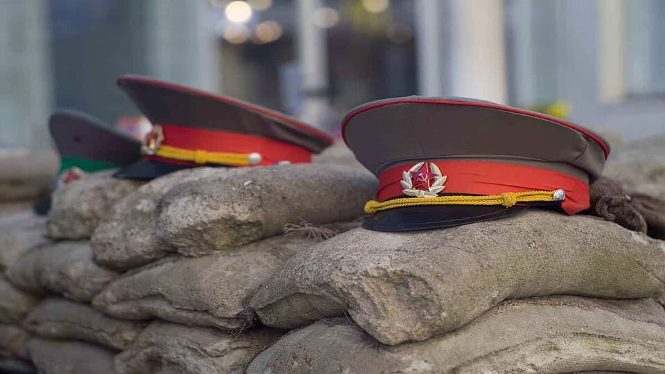 soldeir's hats on top of sandbags at checkpoint charlie