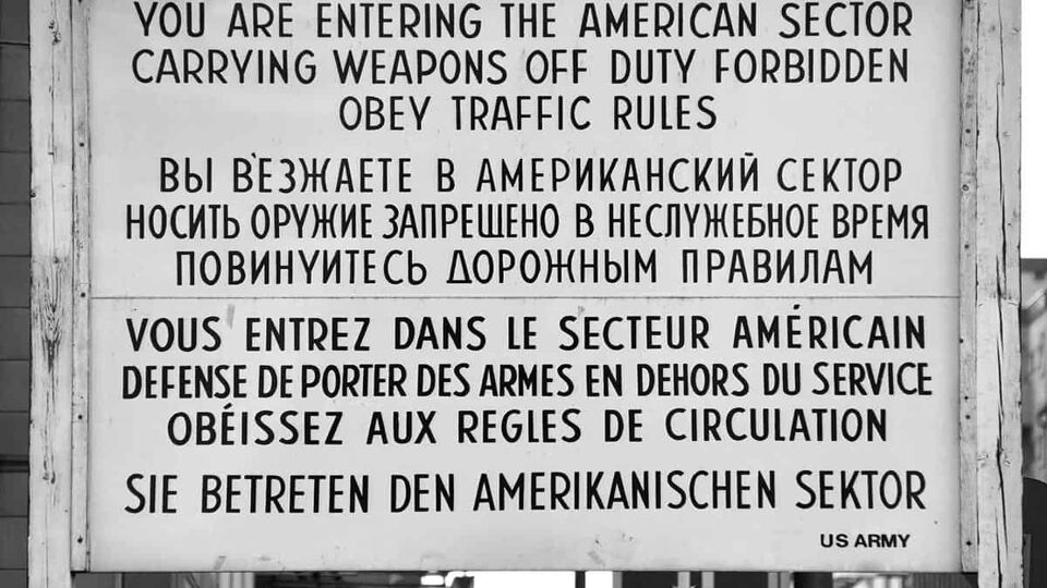 white sign at checkpoint charlie in Berlin