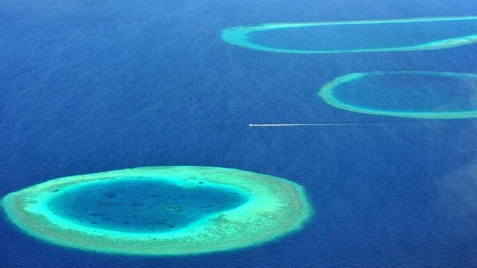 aerial view of several coral atolls