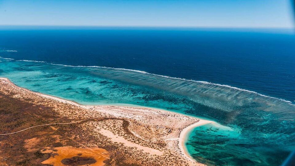 aerial view of a coral reef juist offshore