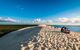 People sat at the peak of the dune enjoying the view of the ocean