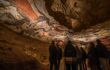 Group of people staring up at ceiling covered in paintings