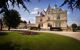 Historical building with decorative flowerbed and green lawn