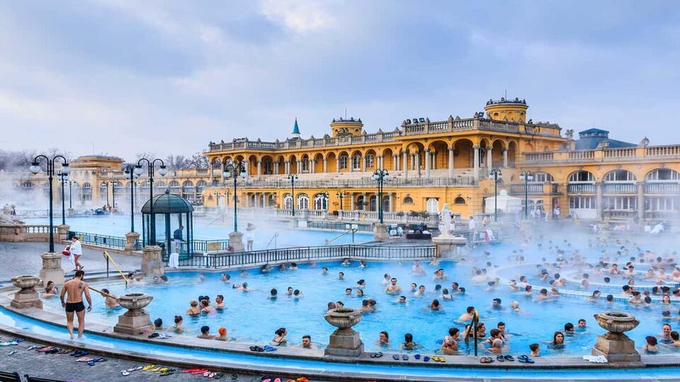 Large outdoor steaming pool filled with people