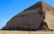 Bent Pyramid at Dahshur Necropolis in an arid landscape compare scale with human -Cairo -Egypt