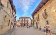 Historical center of Santillana Del Marin summertime, with old golden stone buildings