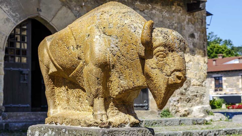 Sculpture Bison Jesus Otero near the houses of the Vine and the Eagle, in Santillana del Mar