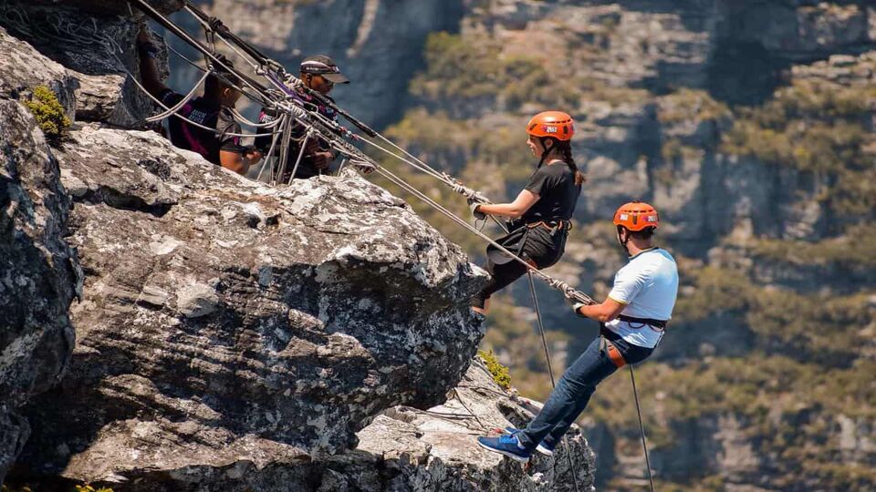 People abseiling during the daytime