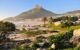 sunrise view of camps bay with lions head behind